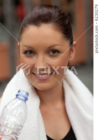 Athletic woman standing with a towel Athletic woman standing with a towel 6230279