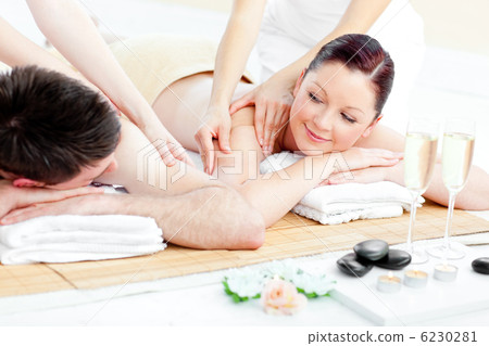Relaxed young couple enjoying a back massage Relaxed young couple enjoying a back massage 6230281