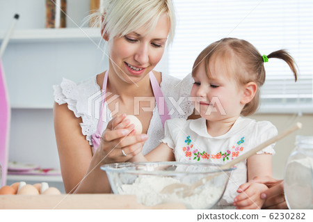 Happy mother and daughter baking together Happy mother and daughter baking together 6230282