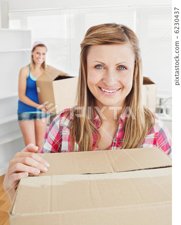 Delighted woman holding boxes after moving 6230437