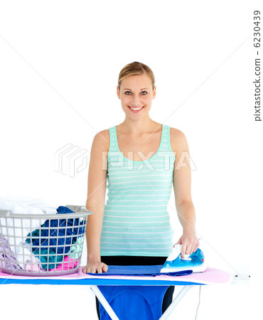 Joyful woman ironing her clothes 6230439