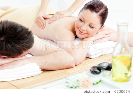 Caucasian young couple receiving a back massage 6230654
