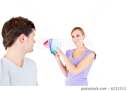 Concentrated young couple choosing color for a room Concentrated young couple choosing color for a room 6231511