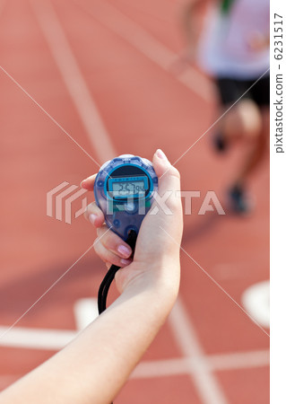 Close-up of a woman holding a chronometer to measure performance Close-up of a woman holding a chronometer to measure performance 6231517