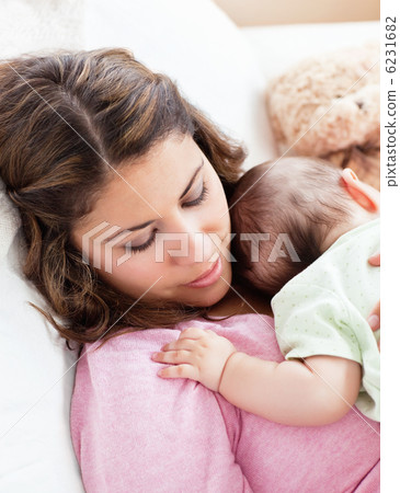 Portrait of a baby and his mother sleeping peacefully in the sof Portrait of a baby and his mother sleeping peacefully in the sof 6231682