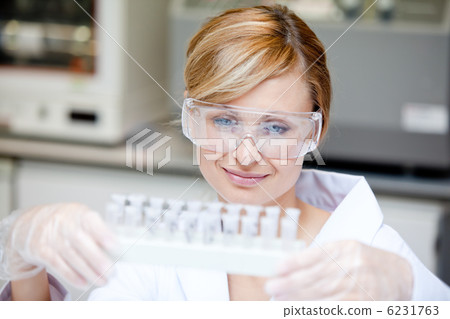 Portrait of a beautiful female scientist holding different sampl Portrait of a beautiful female scientist holding different sampl 6231763