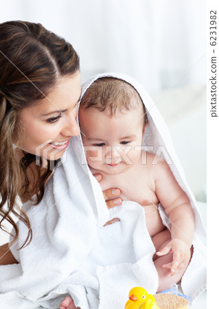 Delighted mother drying her baby after his bath Delighted mother drying her baby after his bath 6231982