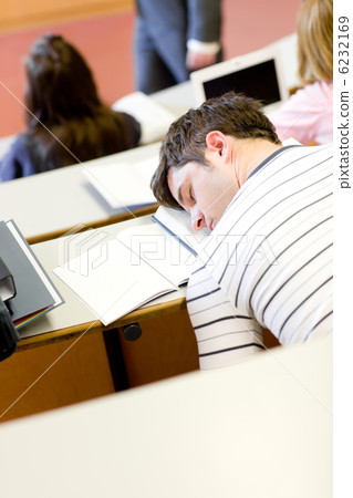 Asleep male student during an university lesson Asleep male student during an university lesson 6232169
