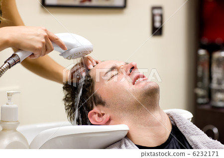 Cute man having his hair washed Cute man having his hair washed 6232171