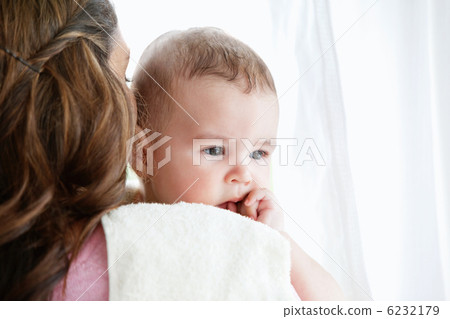 Portrait of a mother pampering her baby after the bath at home 6232179