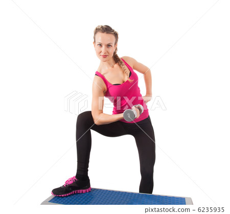 Athletic young woman training with dumbbell 6235935