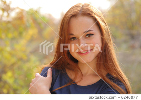 Young redhead woman in the park Young redhead woman in the park 6246877