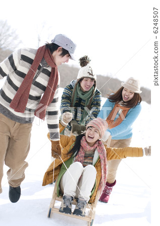 Young people playing on a sled 6248507