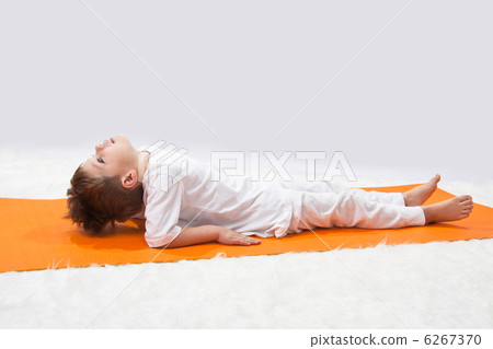 Children's yoga. The little boy does exercise. Children's yoga. The little boy does exercise. 6267370