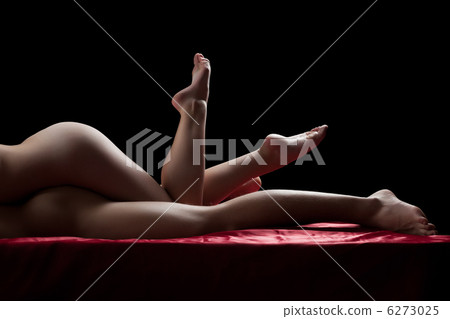 Sexy naked legs of couple having sex on red sheet 6273025