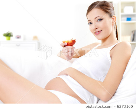 pregnant woman eating fresh red apple 6273160
