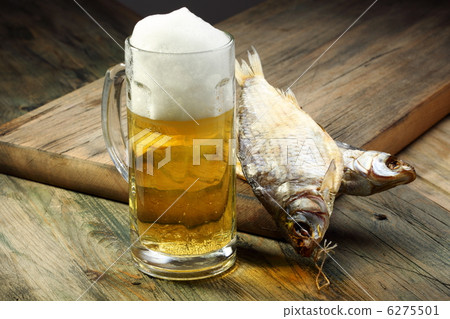 Glass with beer and dried fish. 6275501