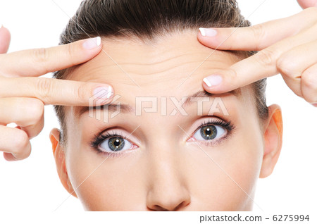 Female face with wrinkles on forehead 6275994