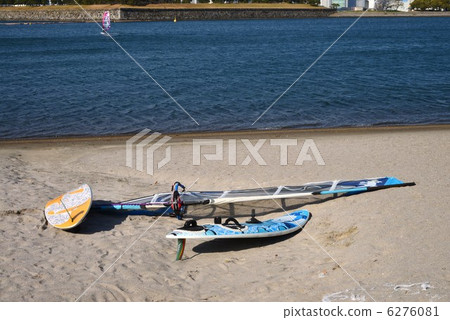 A sailboard placed on the beach A sailboard placed on the beach 6276081