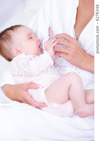 Baby drinking milk from bottle by nurse Baby drinking milk from bottle by nurse 6276348