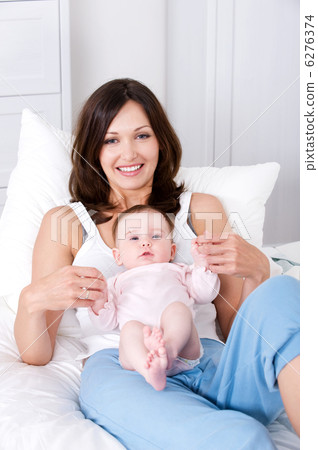 Mother with baby sitting at home in casuals 6276374