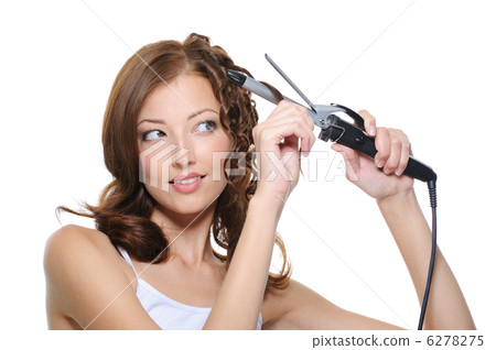 beautiful woman curling her health hair with roller 6278275