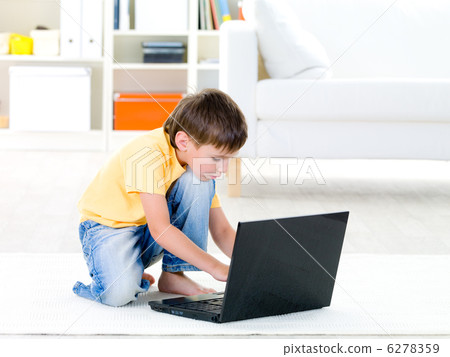 Child playing on laptop at home 6278359