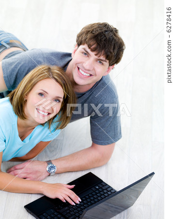 Happy man and woman with laptop 6278416