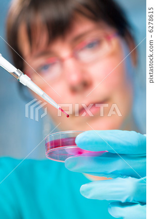 Girl student holding a microtube Girl student holding a microtube 6278615