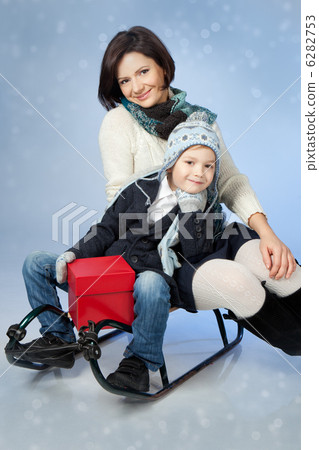 Happy Family Sitting On A Sled At Winter Time 6282753