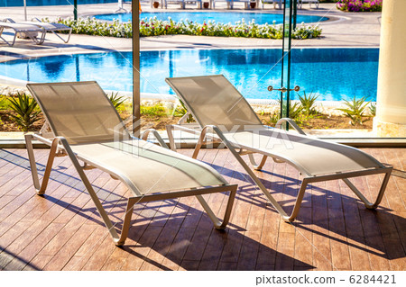 Sunbeds in the indoor swimming pool with views of the outdoor pool Sunbeds in the indoor swimming pool with views of the outdoor pool 6284421