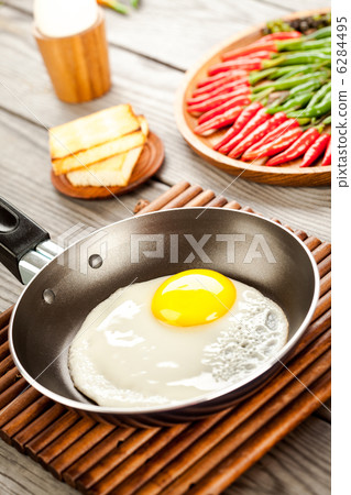 Fried eggs on a wooden table, breakfast Fried eggs on a wooden table, breakfast 6284495