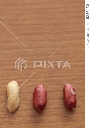A row of skinned and peeled peanuts A row of skinned and peeled peanuts 6286430