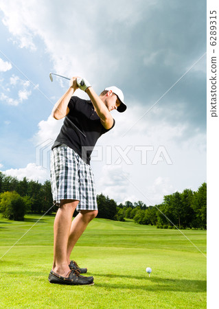 Young golf player on course doing golf swing Young golf player on course doing golf swing 6289315