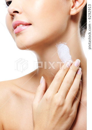 Unrecognizable female  apply  cream on neck 6292913