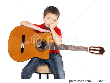 Sad white boy with a acoustic guitar in his hands. Sad white boy with a acoustic guitar in his hands. 6296598