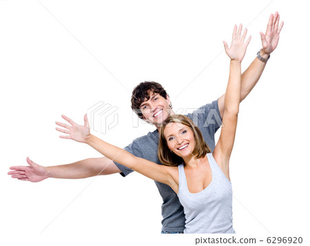 Happy people with the hands lifted upwards Happy people with the hands lifted upwards 6296920