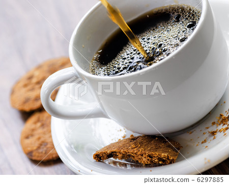 Coffee and oatmeal cookies on wooden table Coffee and oatmeal cookies on wooden table 6297885