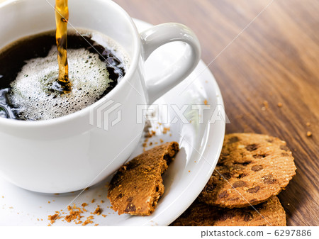 Coffee and oatmeal cookies on wooden table Coffee and oatmeal cookies on wooden table 6297886