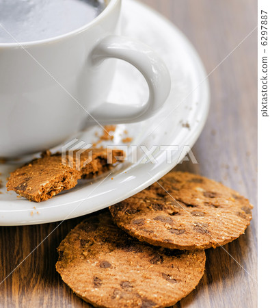 Coffee and oatmeal cookies on wooden table Coffee and oatmeal cookies on wooden table 6297887