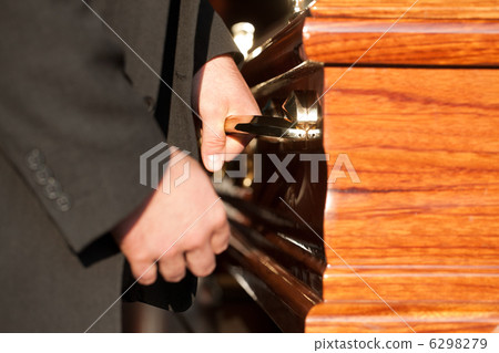 Funeral with casket carried by coffin bearer 6298279