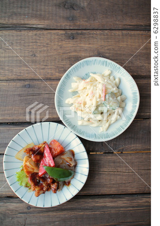 Sweet and sour pork and macaroni salad served on a small plate Sweet and sour pork and macaroni salad served on a small plate 6298837