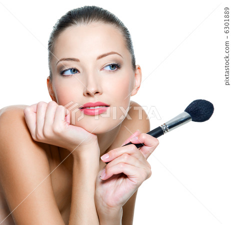 woman holds make-up brushe for applying rouge woman holds make-up brushe for applying rouge 6301889