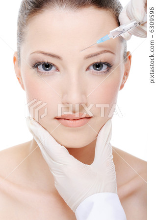 Doctor doing injection of botox on female face 6309596