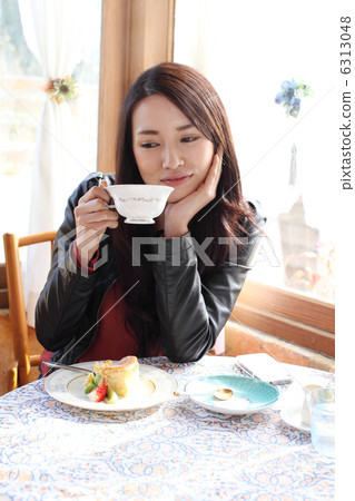 A woman drinking coffee A woman drinking coffee 6313048