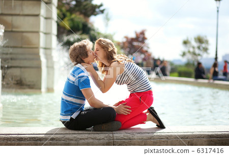 Kissing by the fountain in Paris 6317416