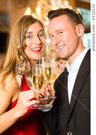 Man and woman tasting Champagne in restaurant 6318228
