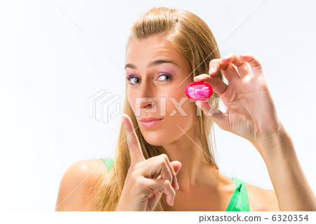 Young woman with a condom 6320354