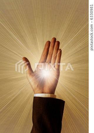 A businessman raises his hand as if to grasp the light. A businessman raises his hand as if to grasp the light. 6330981