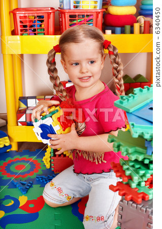 Child with puzzle, block and construction set in play room. Child with puzzle, block and construction set in play room. 6340450